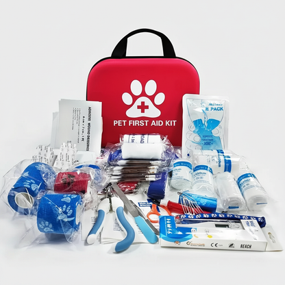 Red pet first aid kit bag with medical supplies laid out in front